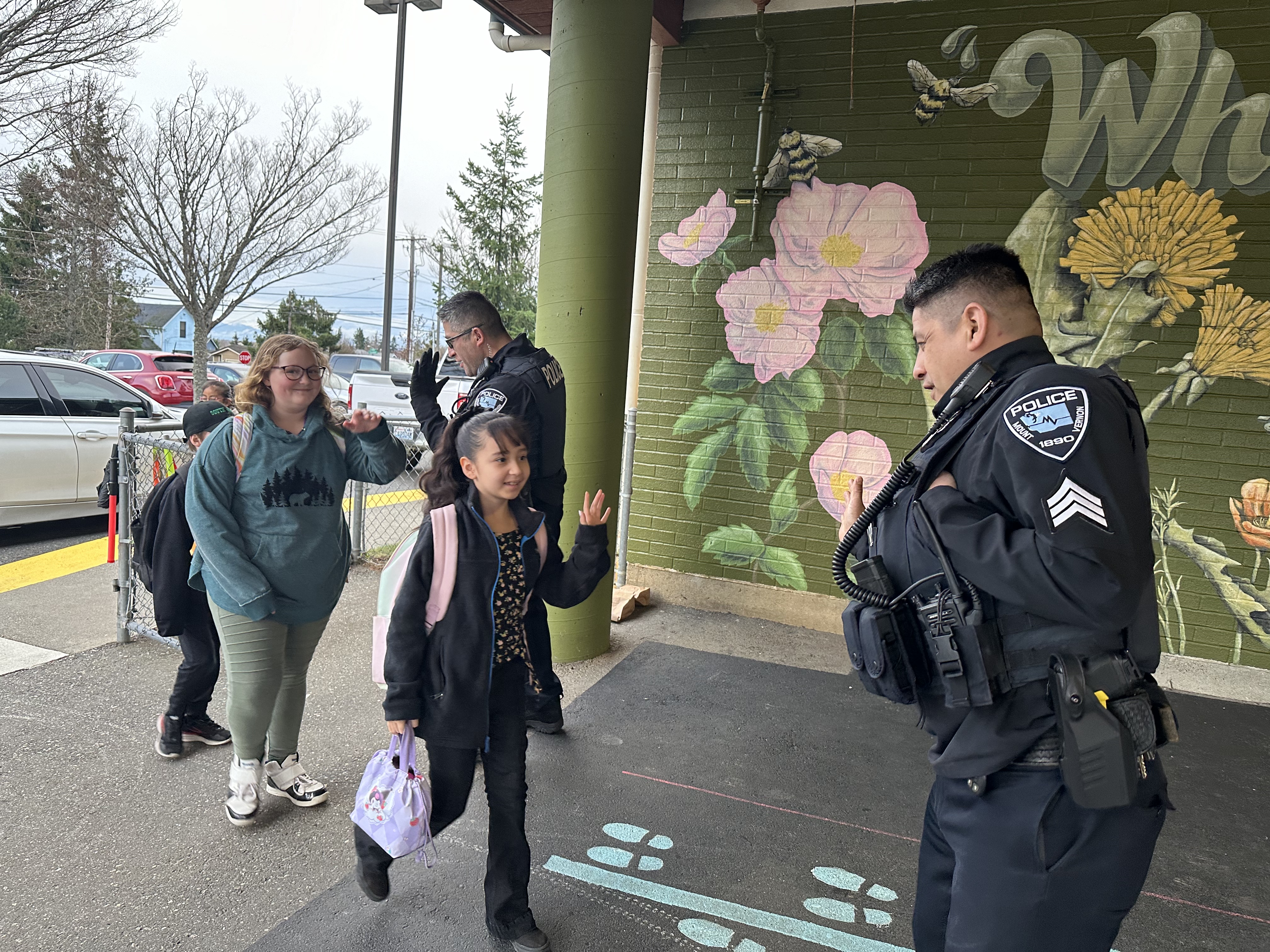 MVPD giving high fives to students